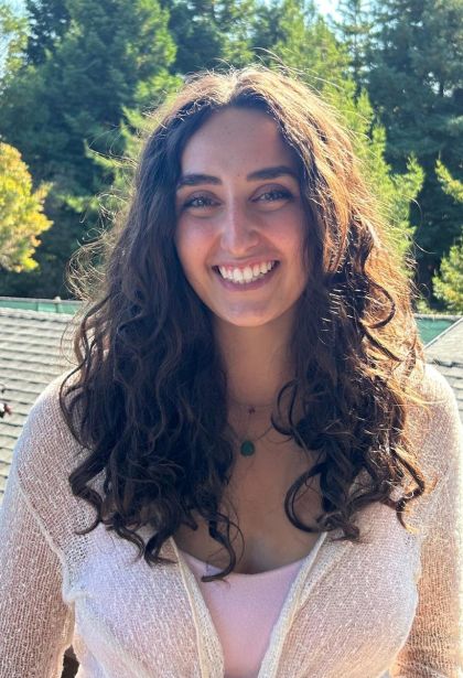 sophia pappalardo, a young woman with long wavy brown hair and a wide smile.